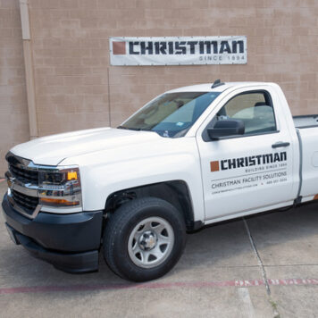 CFS truck with Christman logo on a vinyl banner in the background
